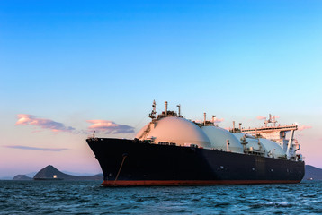 LNG carrier at sunset on the roads.