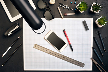 Top view of the builder's workplace, ruler, paper for drawings, compasses, glasses, tablet