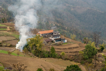 Fototapeta na wymiar terraced slopes and burning grass nepal