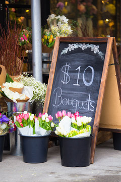 Charming Florist Sidewalk Display Of Flowers And Sign