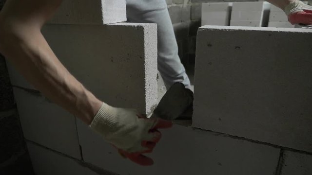 a construction site, a builder puts a wall of gas blocks. 4k.