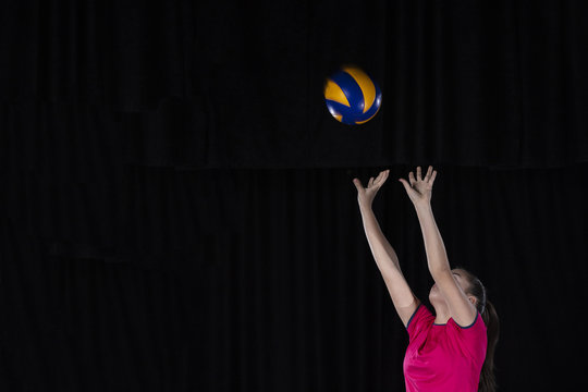 Young Woman Volleyball Player Isolated On Black Background