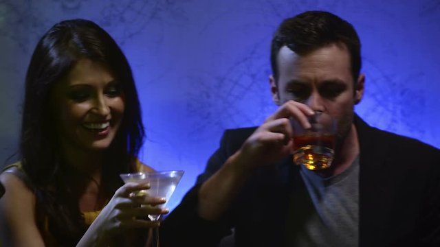 Close up of couples at a table in a club cheer there drinks