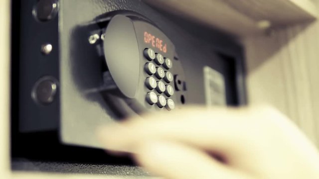 Man Lays Down in a Safe Valuables on Code Lock. Man Hand Opened Safe with code safe. Safe in the hotel closet  cinematic dof
