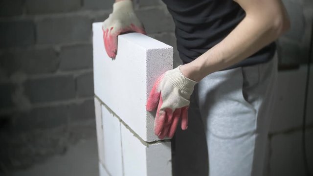 a construction site, a builder puts a wall of gas blocks. 4k.