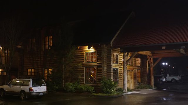 Entrance of a rustic lodge at night in Grants Pass, Oregon