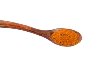 Spoon with ground red pepper isolated on white background.