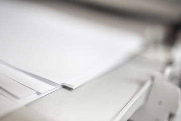Laser Jet Digital Printer Printing paper with dof blur copyspace, focus on paper corner