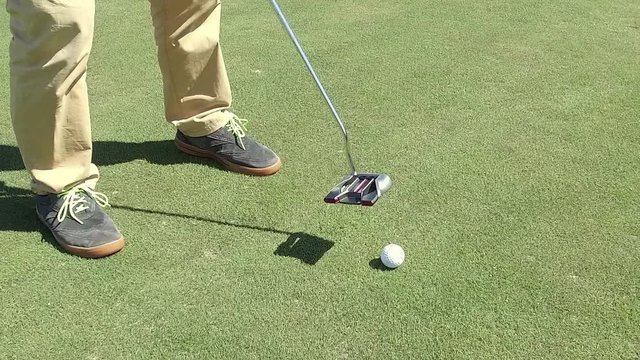 Man preparing for approach shot with iron  SLOW MOTION