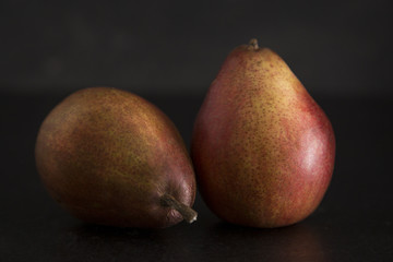 Still LIfe of Fresh Pears on a Dark Surface and Background