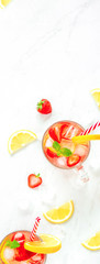 Colorful refreshing strawberry lemonade juice drinks for summer, vertical side banner background