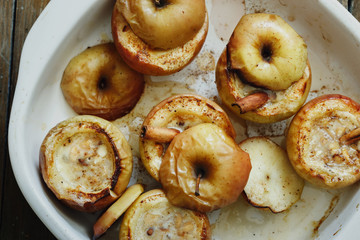 Top view apples topped nuts honey cinnamon baking wooden table