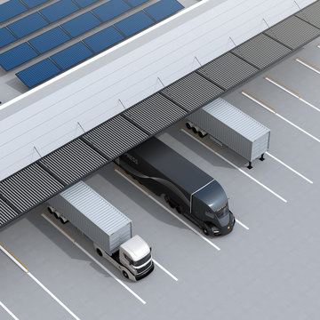Top view of electric trucks parking in front of modern logistics center. Solar panels mounted on the roof. 3D rendering image.
