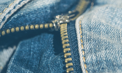 Metal unzipped zipper on classic blue jeans