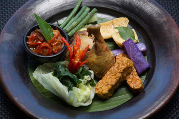 Baked roasted fried chicken drumstick with vegetables