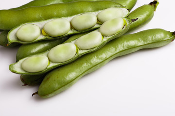 fresh broad beans on a white background