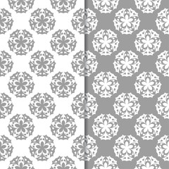 White and gray floral backgrounds. Set of seamless patterns