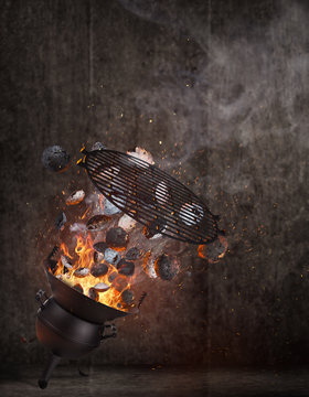 Kettle grill with hot briquettes and cost iron grid flying in the air. High resolution image.