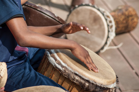 closeup of kids hands on african drums in outdoor