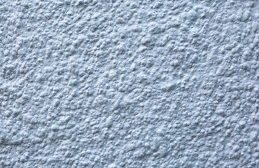 Blue painted roughcast stucco wall