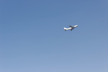 Fototapeta na wymiar soaring plane in the clear sky