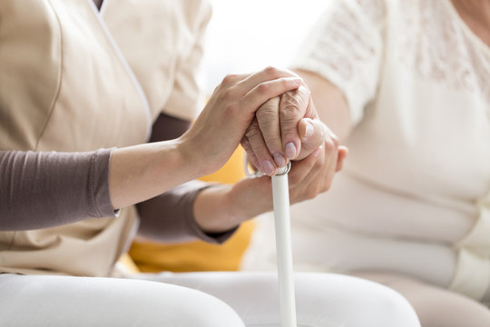 Woman comforting senior