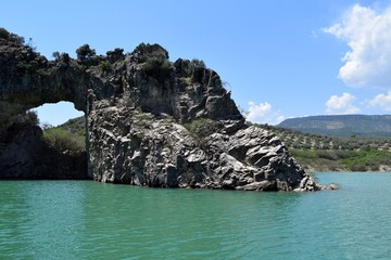 A rock with a hole. Lake. Arapapıstı Kanyon