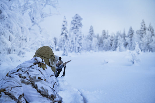 Hunters in winter forest