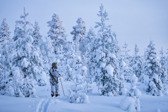Hunters in winter forest