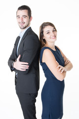 couple Professional business man and woman standing back to back in office looking camera with confident smiles arms crossed