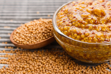mustard in a bowl on a rustic background