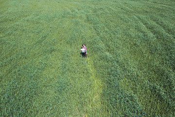 Mother and son in a huge green field