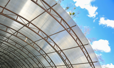 A canopy from polycarbonate arc. Metalware
on the blue sky
