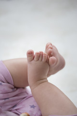 baby feet on white blanket. copy space. selective focus