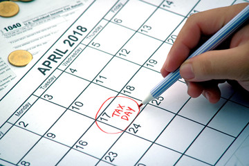 Tax day hand written reminder red circle on 17th april, close up