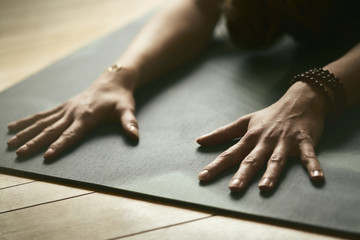 Woman doing yoga on yoga mat