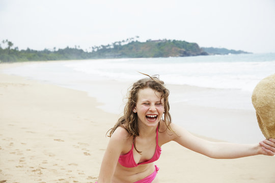 Girl laughing on beach