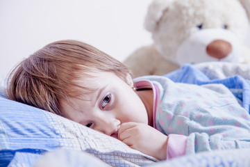 Child girl relaxing in bed. Sleeping time. (Sleep, health treatment)