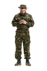 Young army soldier wearing camouflage uniform isolated on white