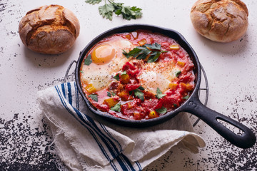 Fries eggs and tomatoes on white background