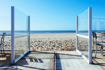 Fototapeta na wymiar door sea view background sun glass blue sand beach nobody sky way