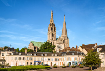 Fototapeta na wymiar Chartres, France - May 21, 2017: View to Cathedral of Our Lady of Chartres from Place Chatelet. Unidentified people present on picture. Copy space in sky.