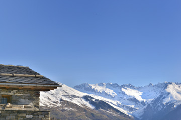 part of traditional chalet in snowy mountain  under blue sky