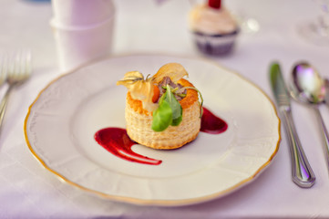 Duck pate on antique plate with cutlery on white table