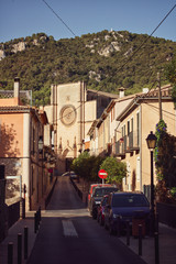 Abandoned street of city Esporles, Mallorca early in the morning with a church in the background