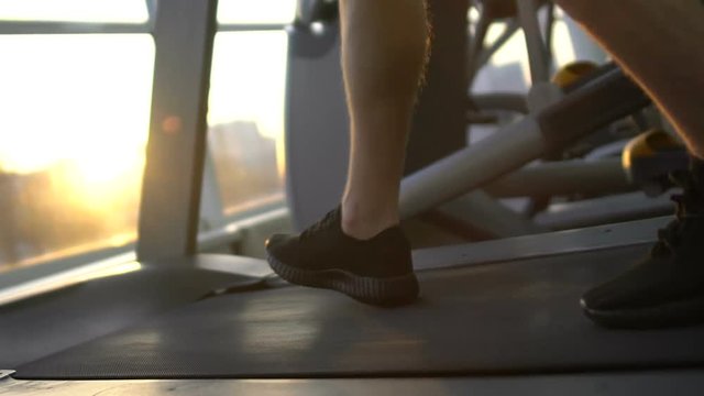 Sportsman running on treadmill, acceleration, progress, attainment of life goal