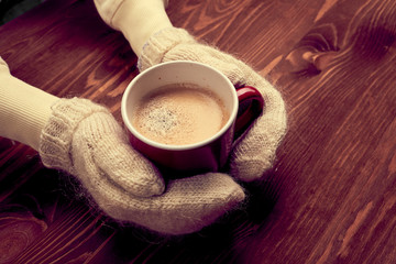 hands holding cup of coffee