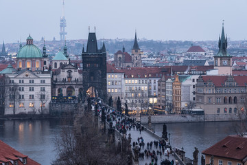 High angle view of the famous Charles Bridge and the old town tower and churches in Prague, Czech Republic capital city at nightfall