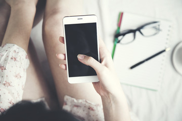 woman hand smart phone on bed