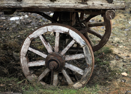 Fragment of the old horse cart with a wooden wheel